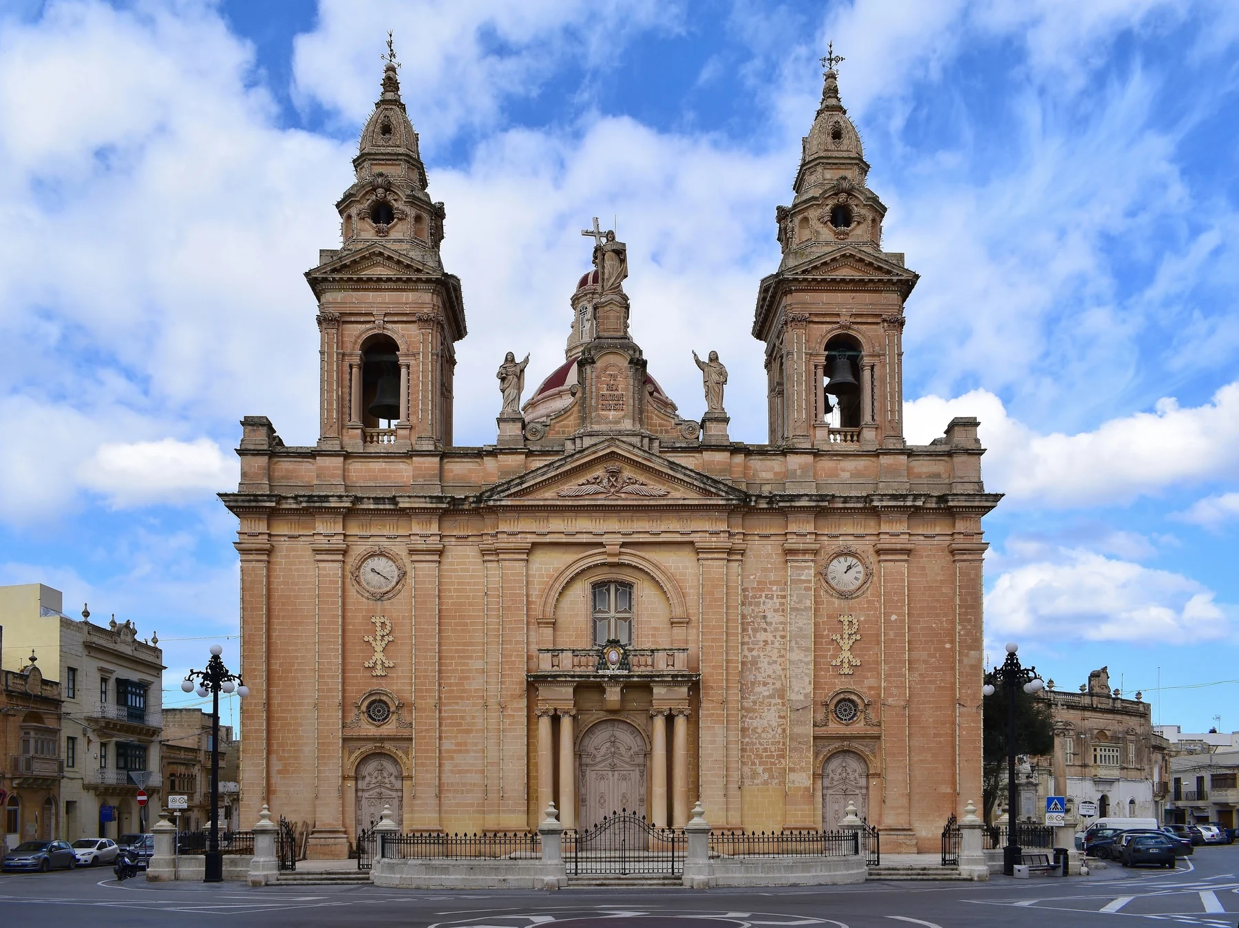 St Andrew parish church, surrounding buildings and road edge in Ħal Luqa, Malta