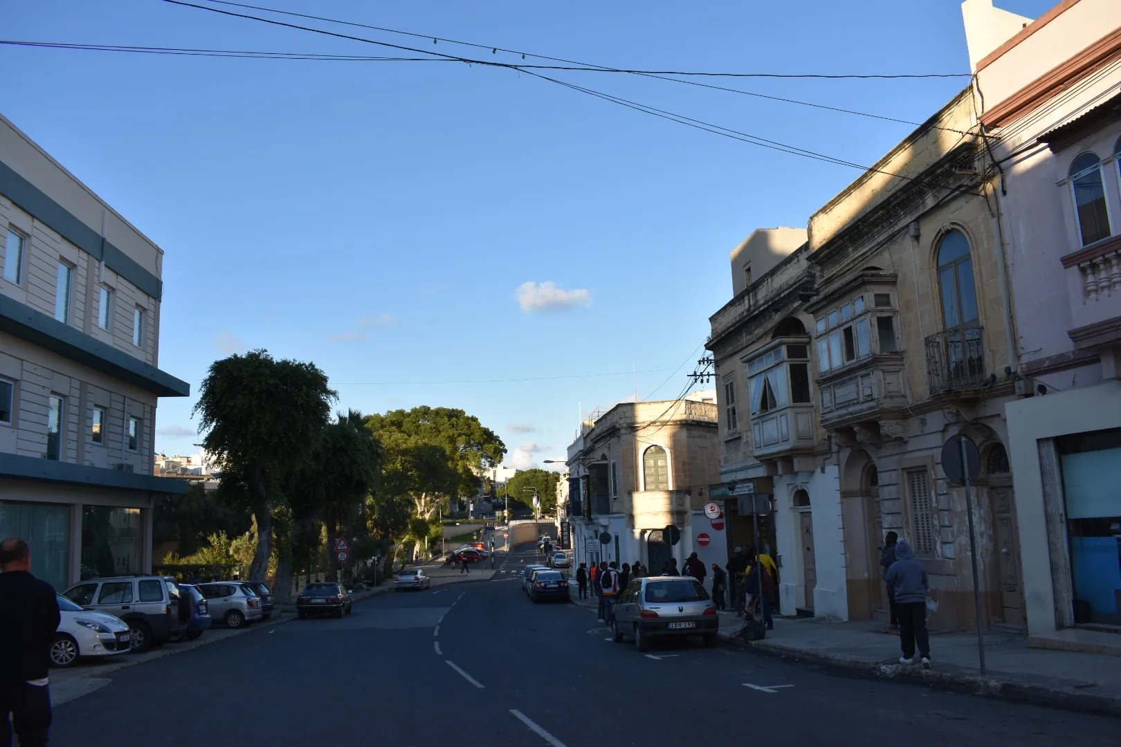 A Marsa street with traditional facades, later buildings and mature trees