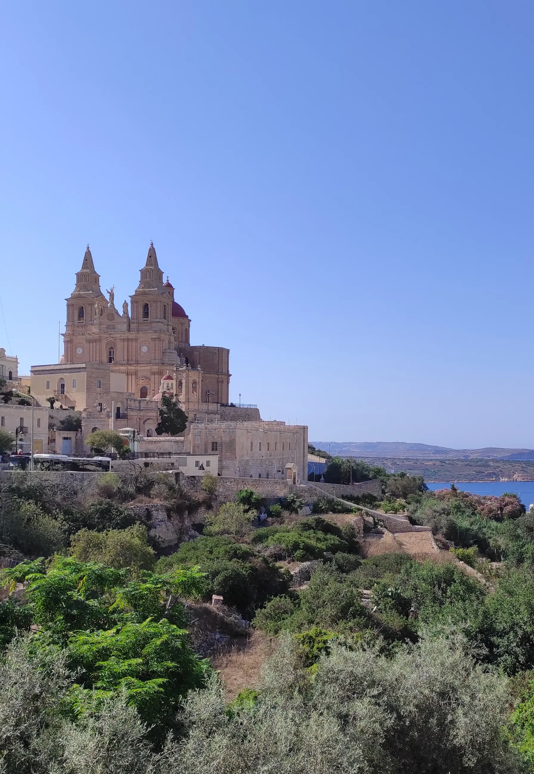 Mellieħa Parish Church on the hillside with the coast in the distance