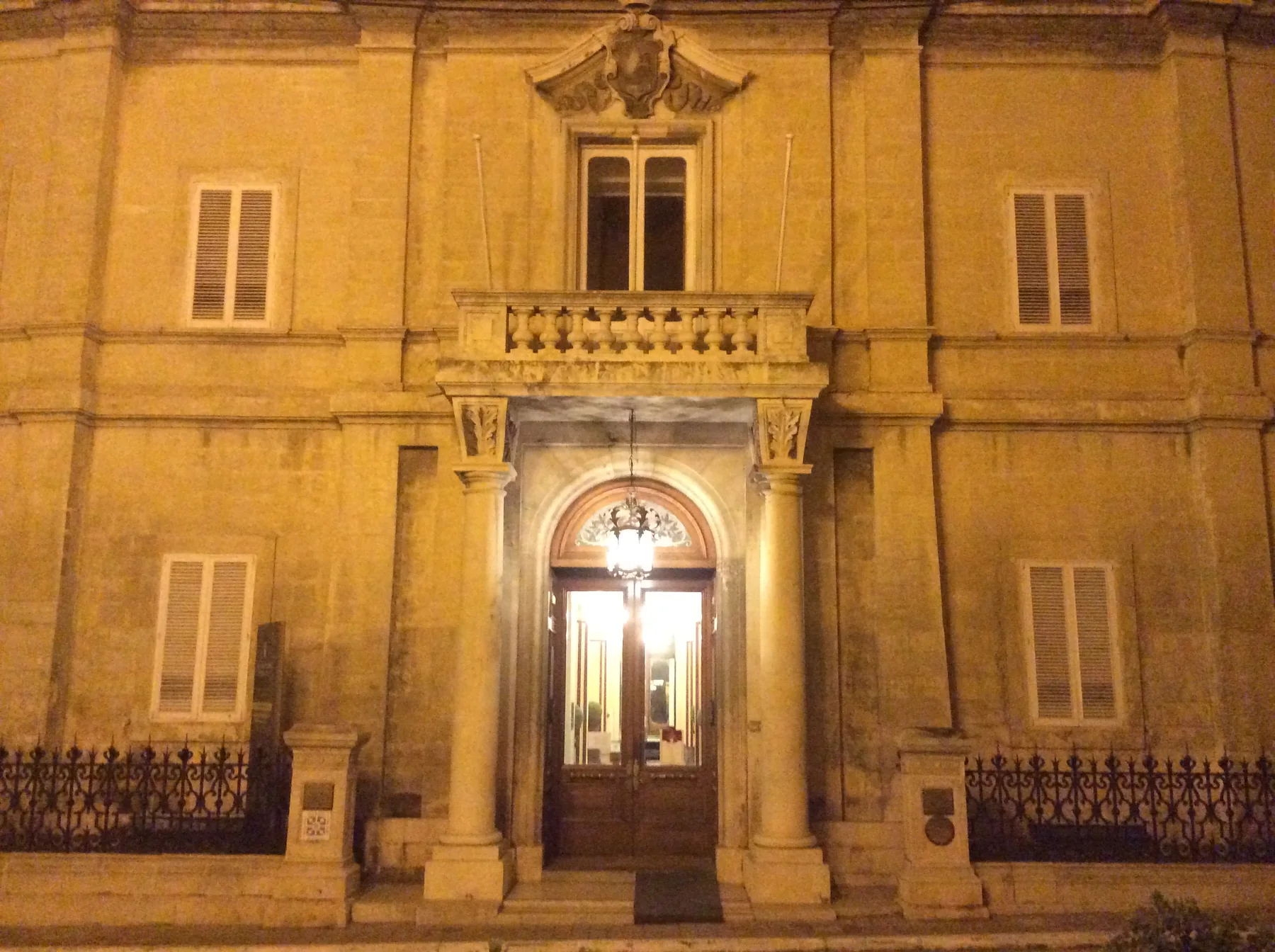 Illuminated facade and entrance of Palazzo Parisio in Naxxar